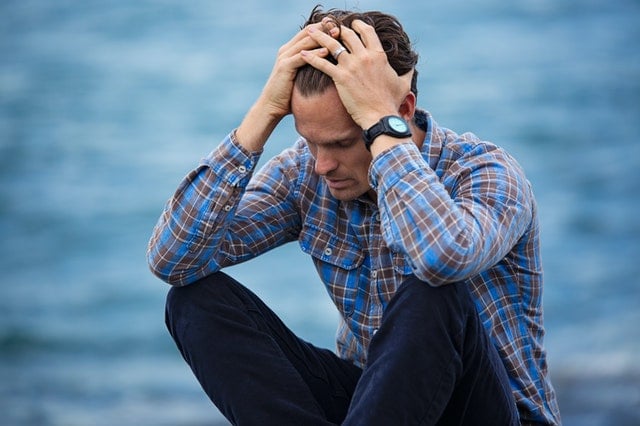 frustrated person with head in hands