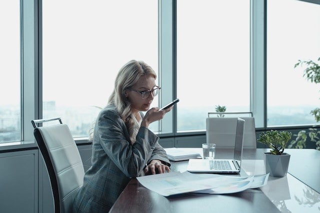 person sitting in office on phone