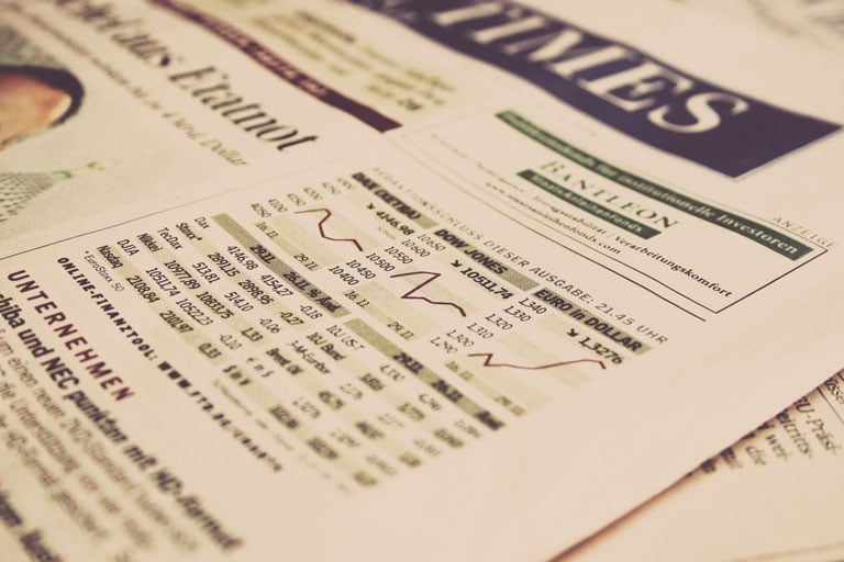 newspaper front page with financial information
